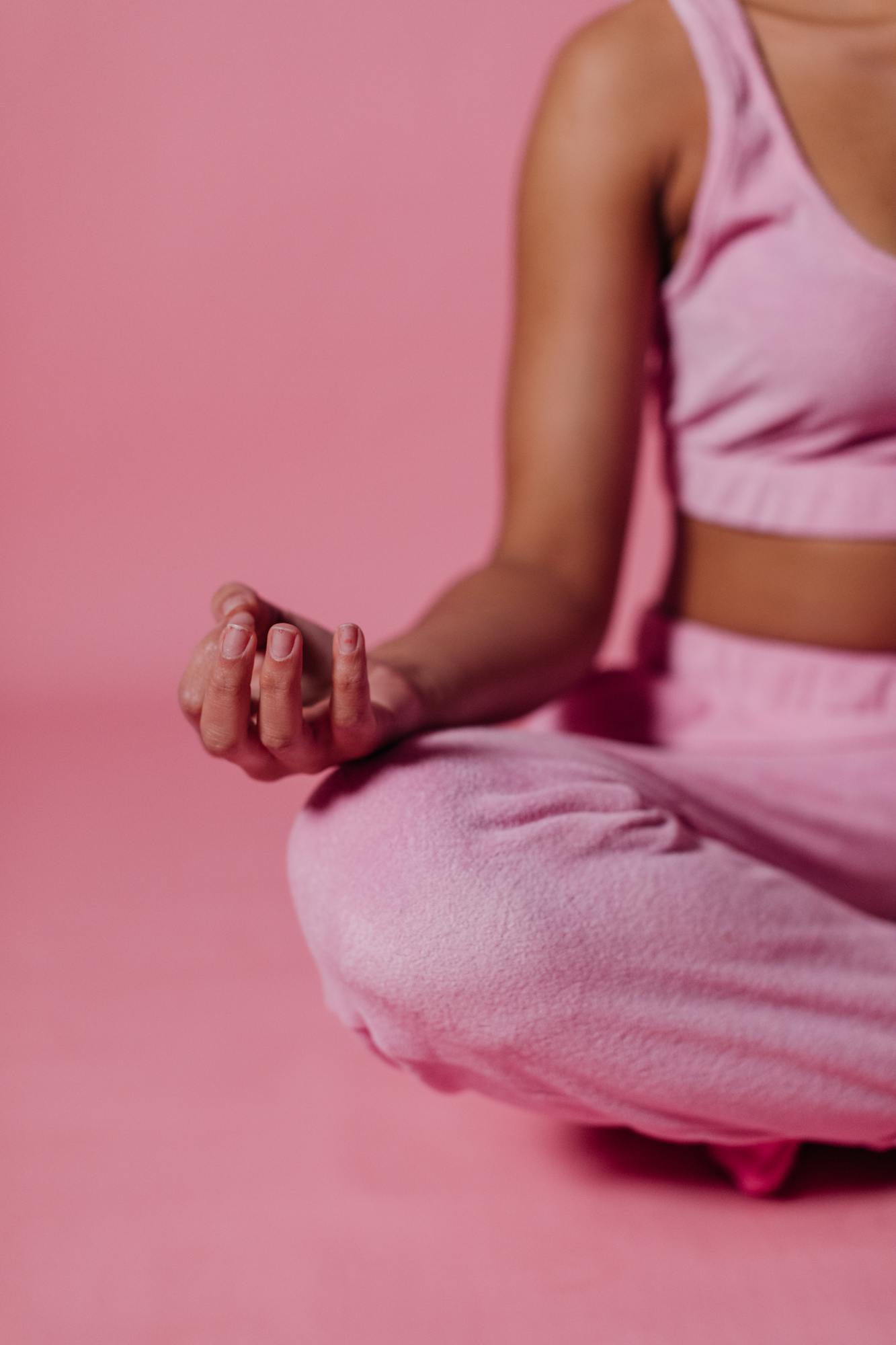 Photo by KoolShooters Close-Up Photo of Woman in Pink Crop Top Meditating