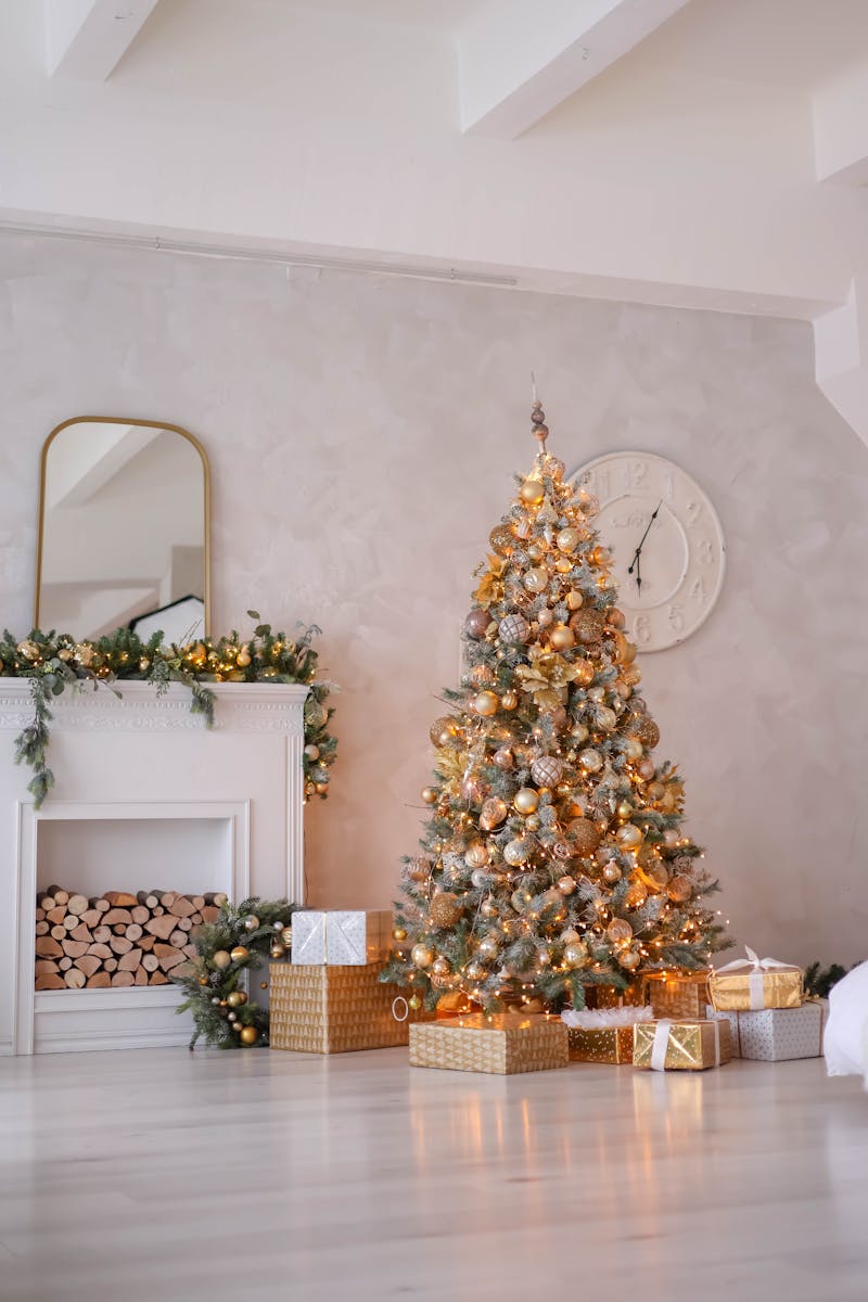 A beautifully decorated Christmas tree with presents in an elegant living room setting.
